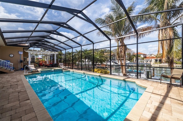 view of swimming pool featuring glass enclosure, a pool with connected hot tub, and a patio