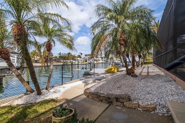 exterior space featuring a water view and fence