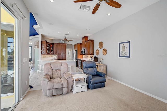 living area featuring recessed lighting, visible vents, light carpet, and ceiling fan