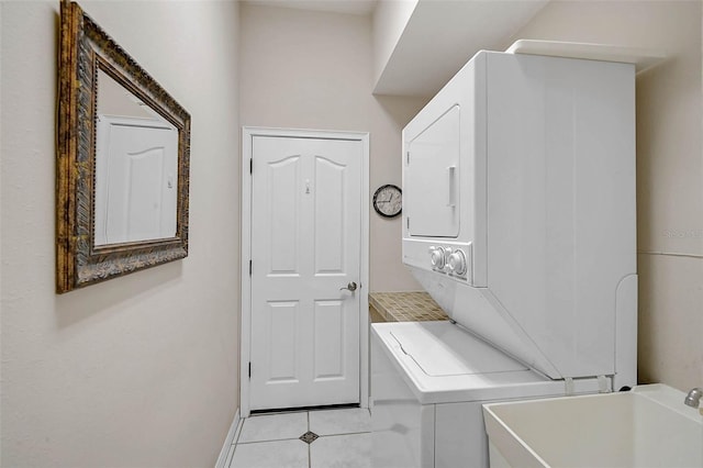 clothes washing area with laundry area, stacked washer / dryer, and light tile patterned floors