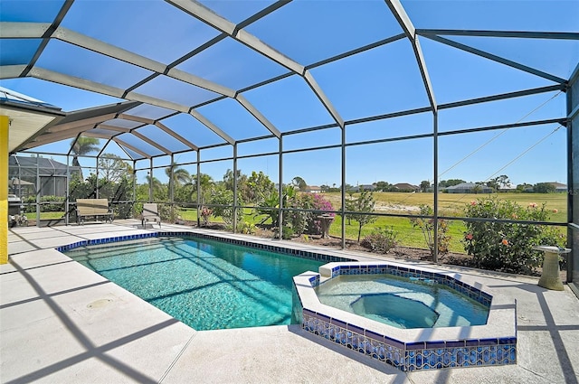 view of swimming pool with a lanai, a pool with connected hot tub, and a patio