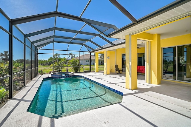 view of pool with a patio area, a pool with connected hot tub, and a lanai