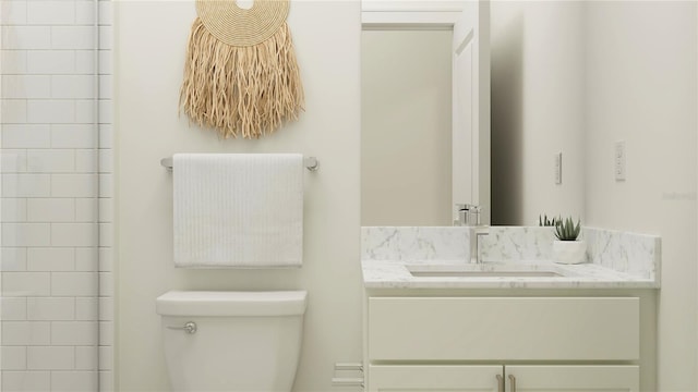 full bathroom featuring vanity and toilet