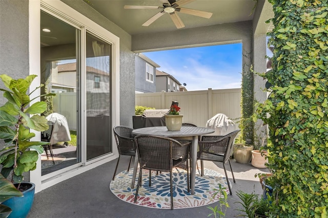 view of patio / terrace with fence, outdoor dining area, and a ceiling fan