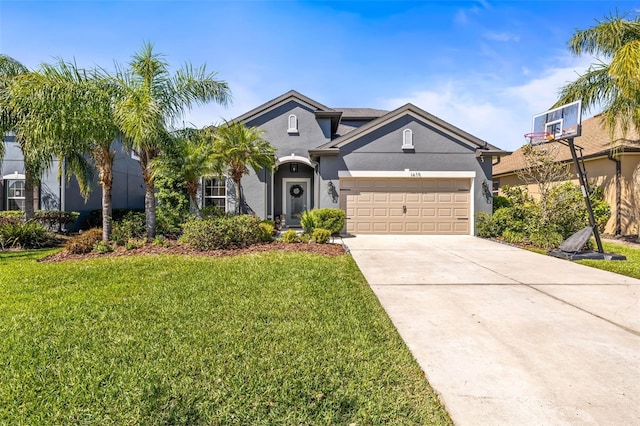 view of front of home with driveway, stucco siding, an attached garage, and a front yard