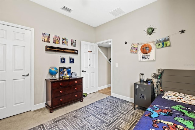 carpeted bedroom with visible vents and baseboards