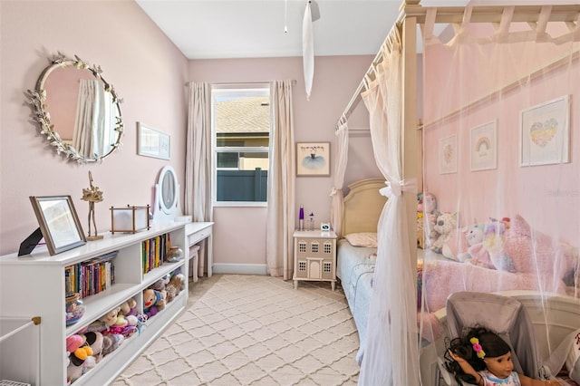 bedroom with light carpet and baseboards