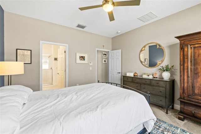 bedroom with light colored carpet, visible vents, ceiling fan, and ensuite bathroom