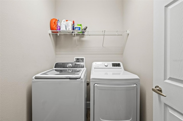 clothes washing area with laundry area and washing machine and clothes dryer