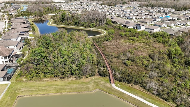 birds eye view of property with a water view and a residential view