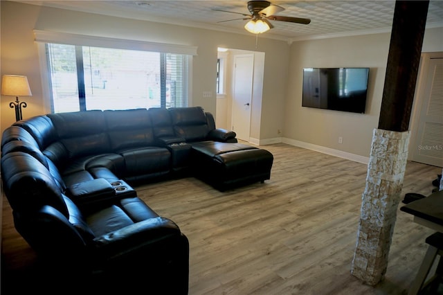 living area featuring baseboards, wood finished floors, a ceiling fan, and crown molding