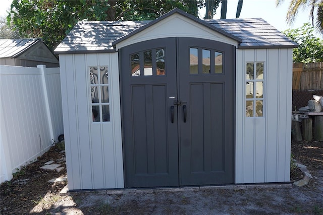 view of shed with fence