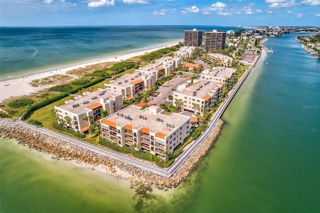 drone / aerial view featuring a beach view and a water view