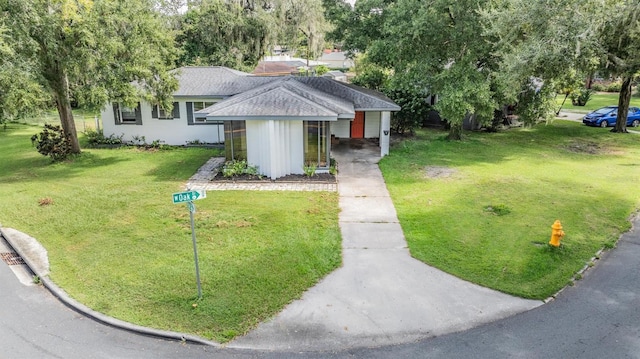 view of front of home with a front lawn and roof with shingles