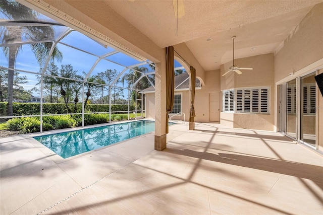 outdoor pool featuring a ceiling fan, a lanai, and a patio area