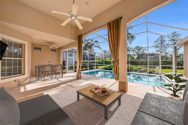 exterior space with ceiling fan, an outdoor pool, a lanai, and outdoor dining space