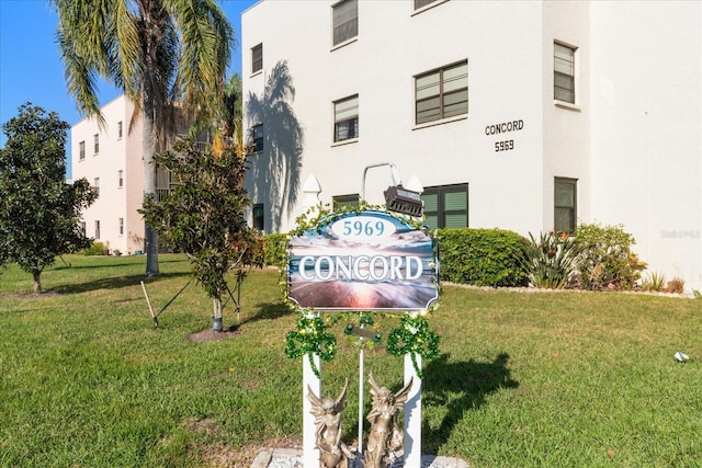 community / neighborhood sign with a lawn