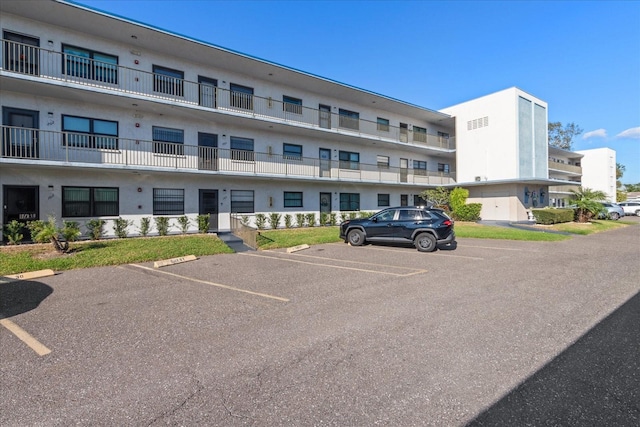 view of building exterior with uncovered parking