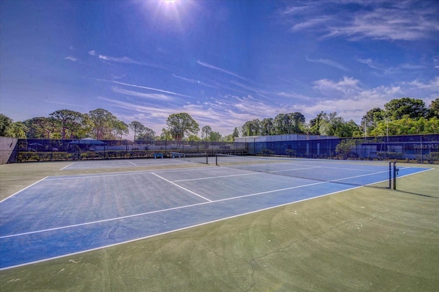 view of sport court featuring fence