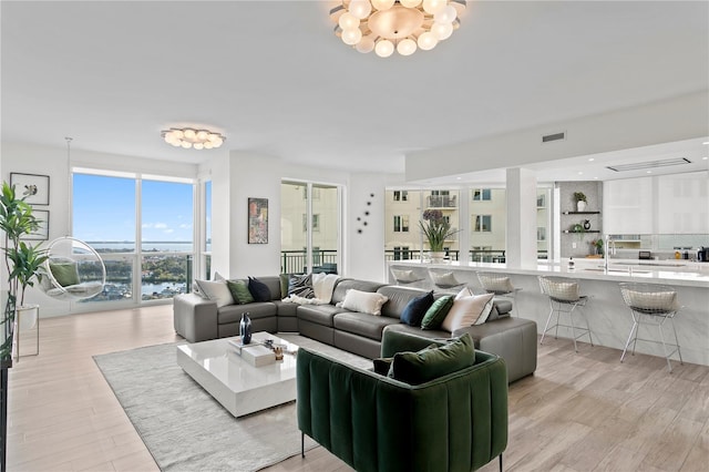 living room with light wood finished floors and visible vents