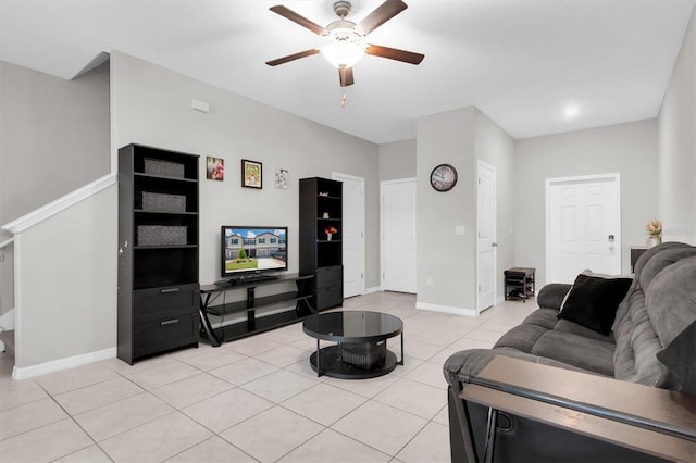 living room featuring ceiling fan, baseboards, and light tile patterned flooring