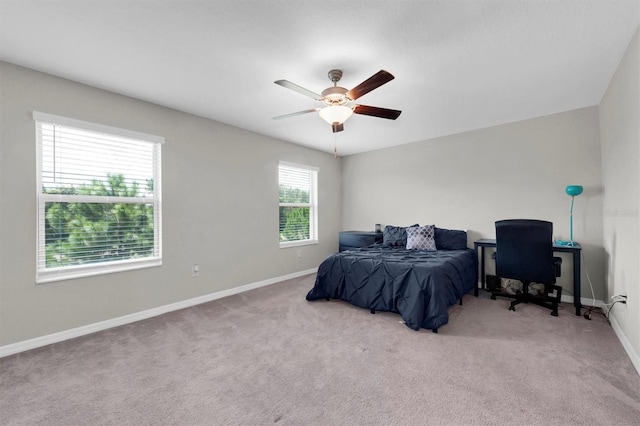 bedroom with light carpet, ceiling fan, and baseboards