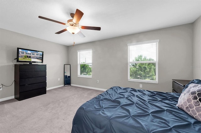 carpeted bedroom featuring a ceiling fan and baseboards