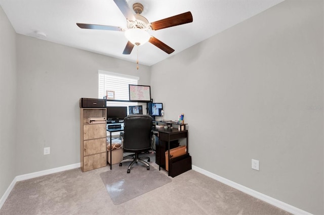 office space with carpet floors, a ceiling fan, and baseboards