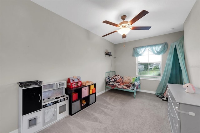 game room with light carpet, ceiling fan, and baseboards