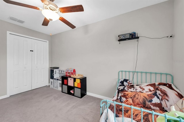 bedroom featuring a closet, visible vents, carpet flooring, ceiling fan, and baseboards