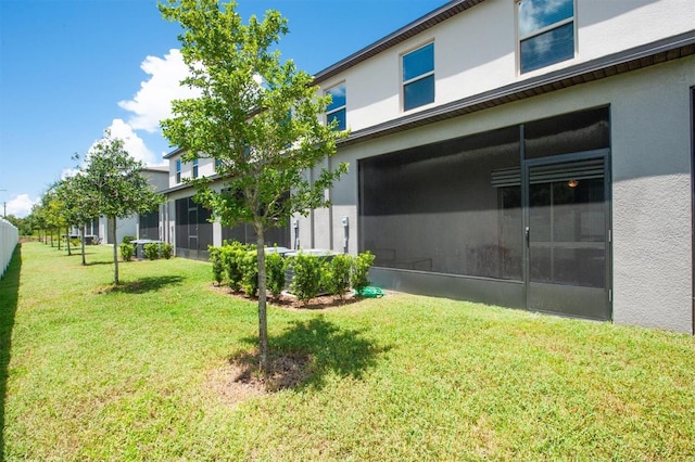 view of yard with a sunroom and an attached garage