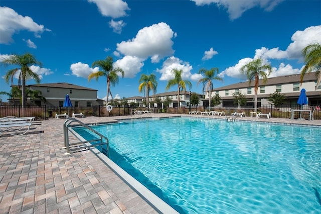 community pool featuring a patio area and fence