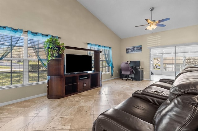 living area featuring high vaulted ceiling, baseboards, and a ceiling fan