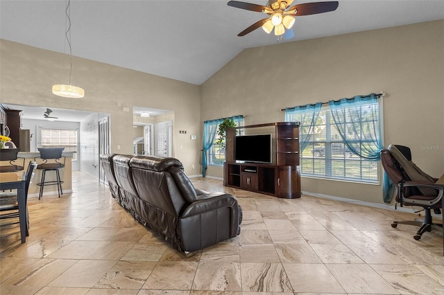 living area with high vaulted ceiling, baseboards, and a ceiling fan