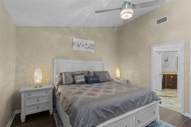 bedroom with baseboards, visible vents, vaulted ceiling, and dark wood-style flooring