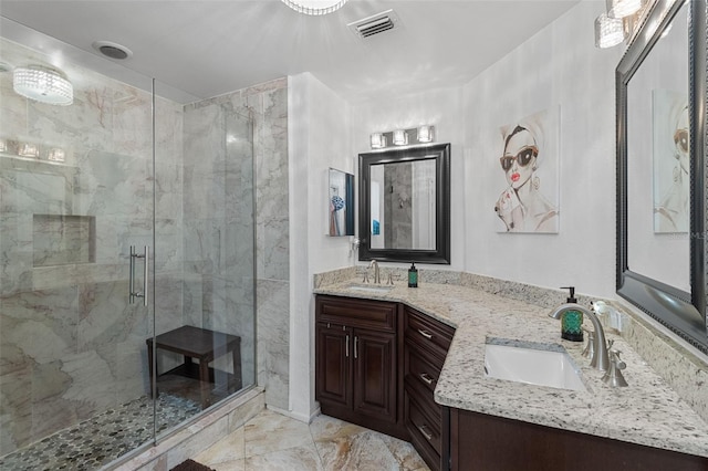 full bath featuring double vanity, a sink, visible vents, and a shower stall