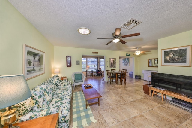 living area featuring visible vents and a textured ceiling