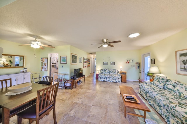 living area featuring a textured ceiling and ceiling fan