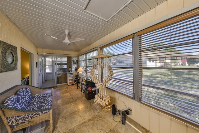 sunroom / solarium featuring a ceiling fan