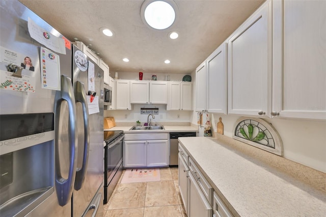 kitchen featuring a sink, appliances with stainless steel finishes, recessed lighting, and light countertops