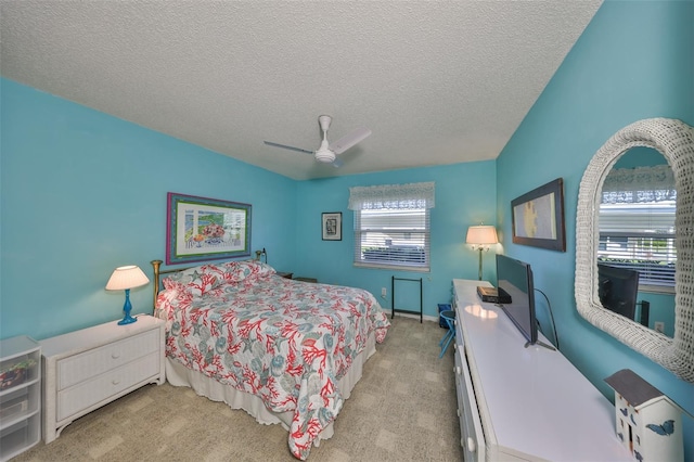 bedroom featuring a textured ceiling, ceiling fan, and carpet floors