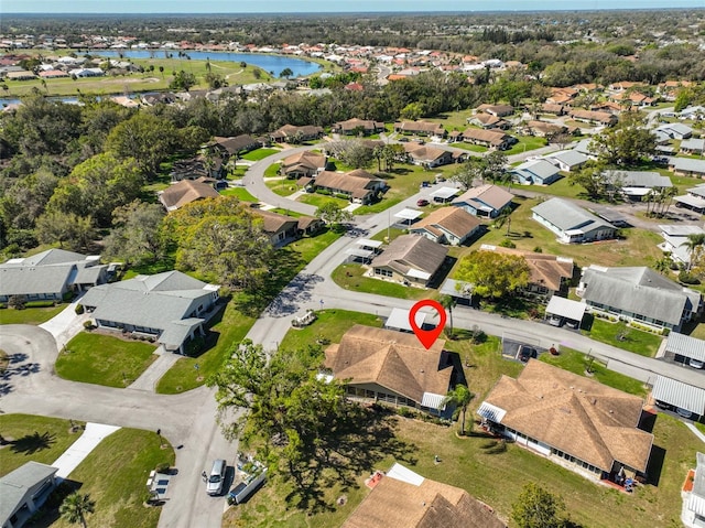 birds eye view of property with a residential view and a water view