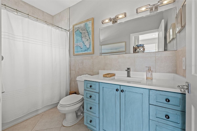 bathroom with toilet, tile patterned flooring, tile walls, and vanity