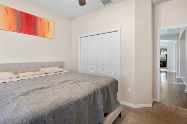 bedroom with baseboards, carpet, visible vents, and a closet