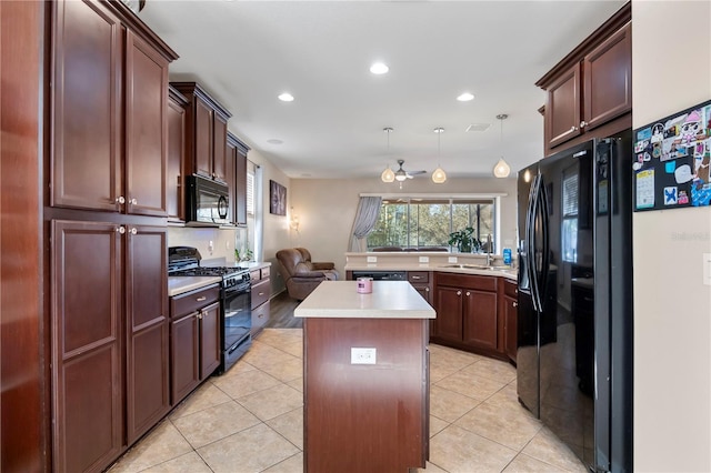 kitchen with light tile patterned flooring, a kitchen island, a sink, light countertops, and black appliances