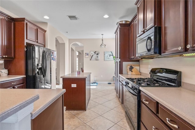 kitchen with arched walkways, light tile patterned flooring, visible vents, light countertops, and black appliances