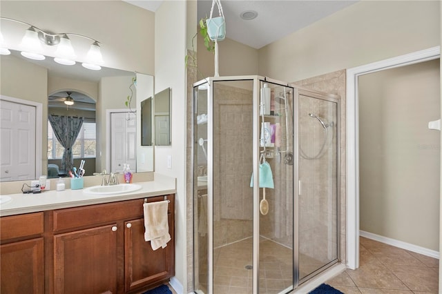 full bathroom featuring a stall shower, tile patterned flooring, ceiling fan, and vanity