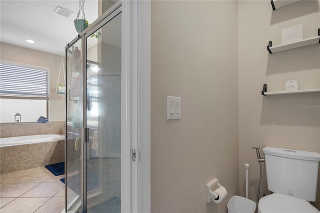 bathroom featuring visible vents, toilet, a shower stall, tile patterned flooring, and a bath