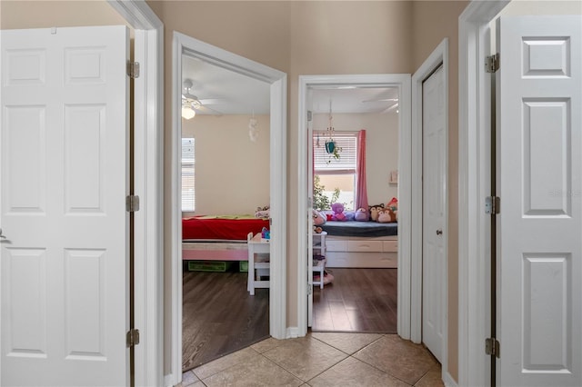 hall featuring light tile patterned floors