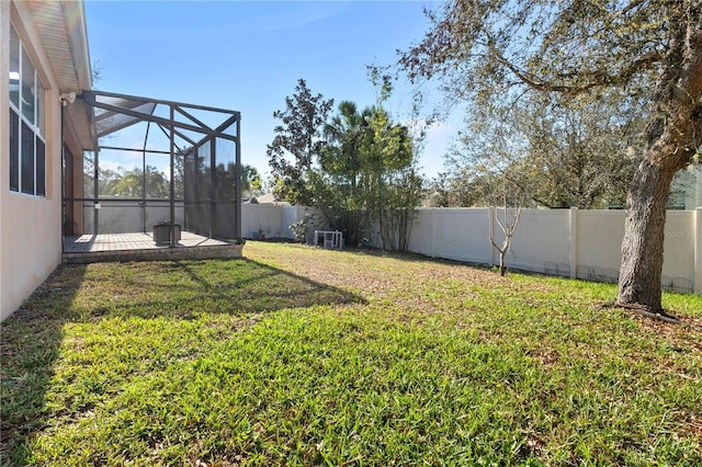 view of yard featuring a lanai and a fenced backyard